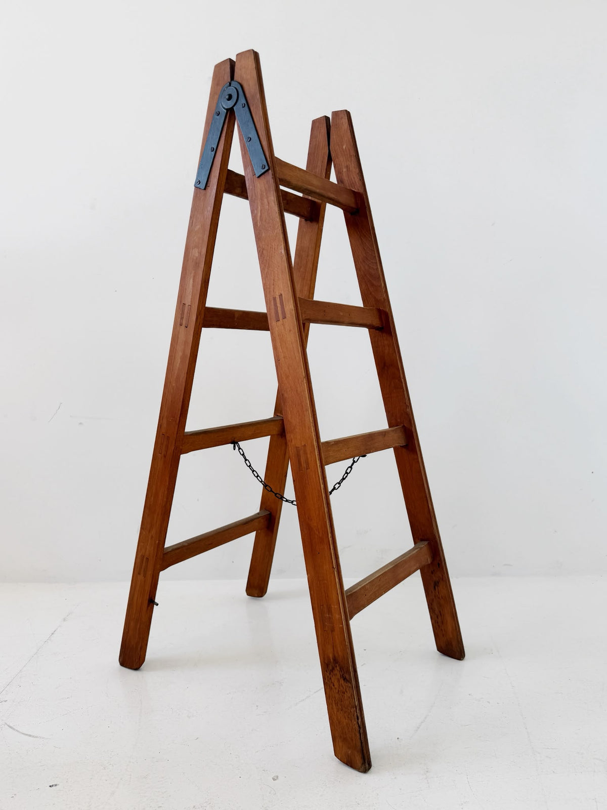 Wooden A-frame ladder with iron hardware, mid-20th century