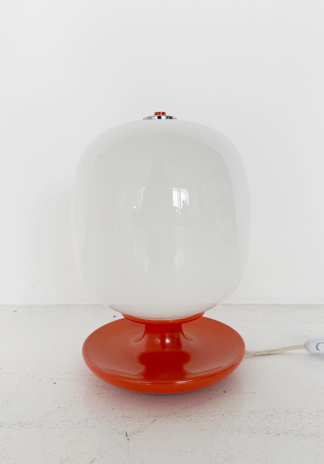 Table lamp with orange base and white glass diffuser