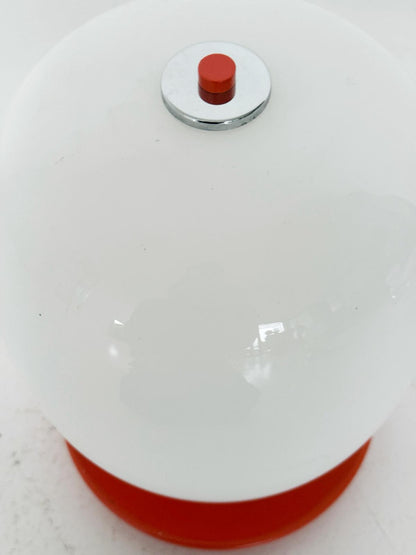 Table lamp with orange base and white glass diffuser