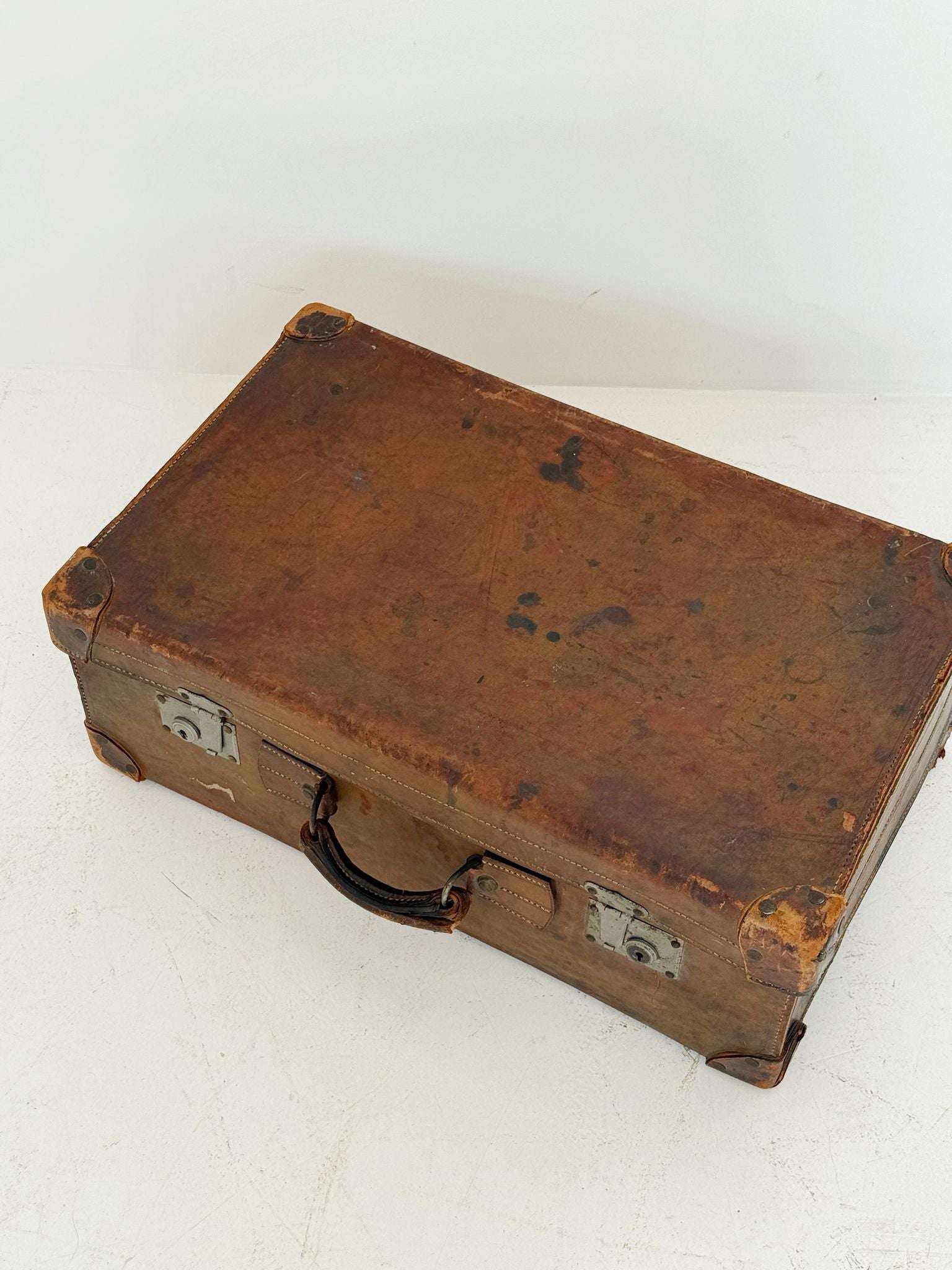 Leather travel suitcase with hotel labels