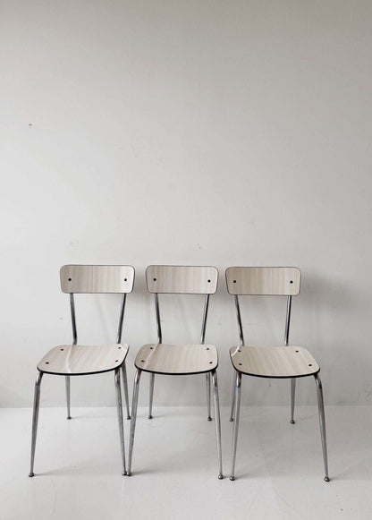 Three beige formica chairs