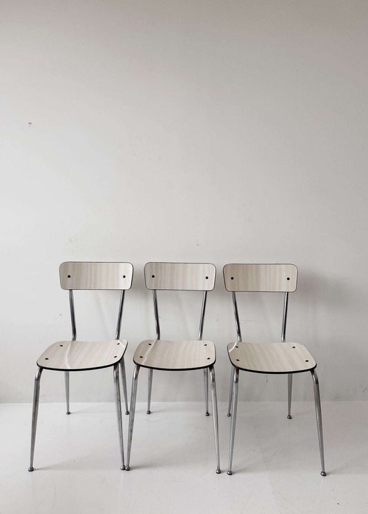 Three beige formica chairs