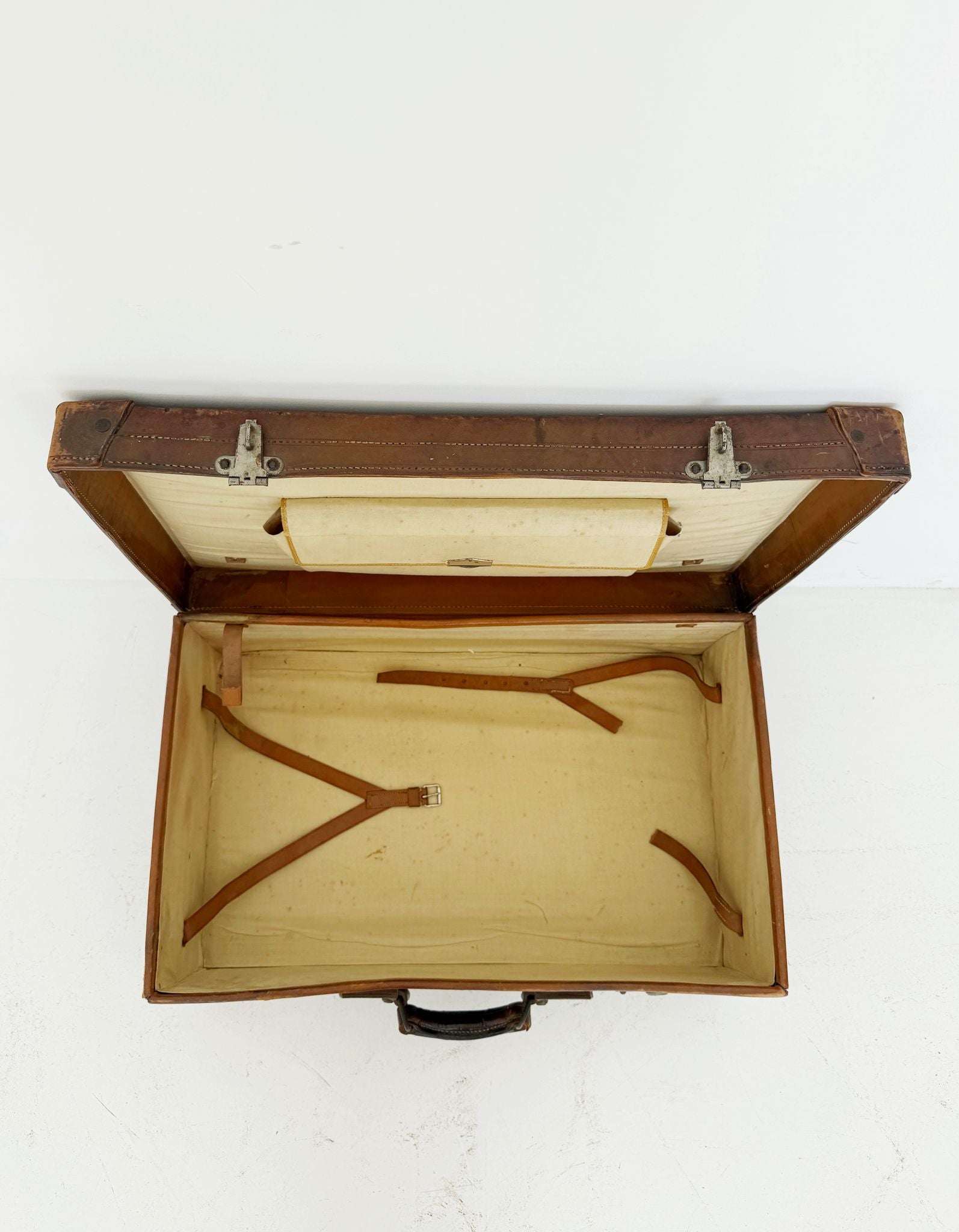 Leather travel suitcase with hotel labels